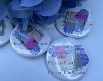 May include: Four white round buttons with colorful designs featuring books, flowers, and the text "Pioneer Service School". The buttons are on a blue background.