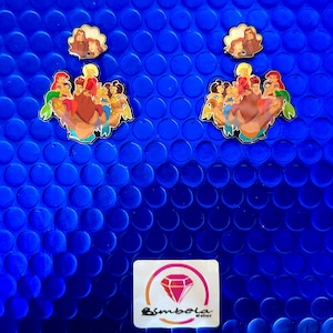 May include: Enamel pins featuring cartoon characters on a blue background. The pins depict a group of characters and a smaller pin with three figures. A logo with a diamond is at the bottom.