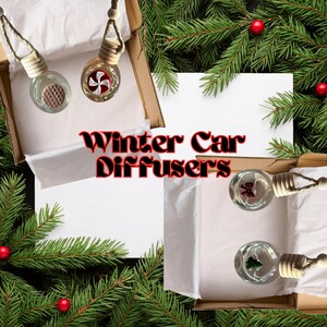 May include: Three glass car air fresheners in boxes. The air fresheners are decorated with a red and white candy cane, a red bow, and a green pine tree. The boxes are surrounded by green pine branches with red berries. The text "Winter Car Diffusers" is written in black letters on a white background.
