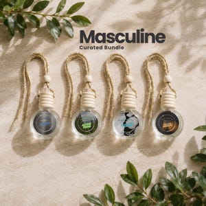 May include: Four small, round glass car air freshener bottles with light wood caps and braided tan hanging cords. Each bottle features a circular label with text including "Masculine Curated Bundle" at the top. The labels display different scents: Titanium, Alpine Fresh, Sandalwood, and Vintage Leather.