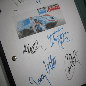 May include: A white script page with signatures from the cast and crew of the movie "Ford v Ferrari". The signatures include Matt Damon, Christian Bale,  James Mangold, and  Tracy Letts. The page also features a photo of a blue and red race car.