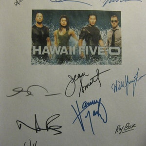May include: A white sheet of paper with multiple signatures in blue and black ink. The signatures include "Scott Caan", "Alex O'Loughlin", "Daniel Dae Kim", "Taylor Wily", "Will Yun Lee", "Jorge Garcia", "Chi McBride", "Ray  Bose", "William Sadler", and "Ian Anthony Dale". The signatures are surrounding a photo of the cast of the TV show "Hawaii Five-O".