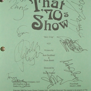 May include: A green script page for the TV show "That '70s Show" with the title "Holy Crap" and episode number 223. The page includes the names of the writers, Rob DesHotel and Dean Batali, and the director, David Trajner. The page also includes the copyright information for the Carsey-Werner Company, LLC.
