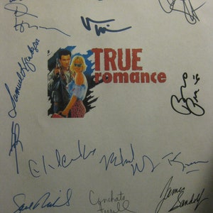 May include: A white sheet of paper with blue and green signatures from the cast of the movie "True Romance". The signatures include Patricia Arquette, Brad Pitt, and others. The movie title is printed in red and black.