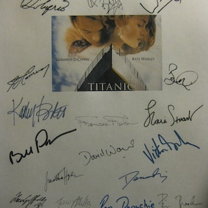 May include: A black and white photograph of the Titanic movie poster featuring the signatures of the cast and crew, including Leonardo DiCaprio, Kate Winslet, Billy Zane, Kathy Bates, Frances Fisher, Gloria Stuart, and more.
