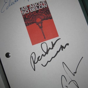 May include: A white sheet of paper with three signatures. The top signature is in blue ink and reads "Edwin Hodge". Below that is a red and black poster with the text "As Above So Below". The poster is signed in black ink by "Peter Weller" and "B. Flynn".