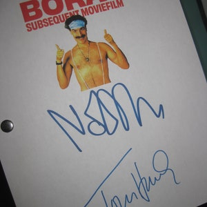 May include: A white script cover for the movie "Borat Subsequent Moviefilm" with a photo of Sacha Baron Cohen in character as Borat. The cover is signed by Sacha Baron Cohen in blue ink.