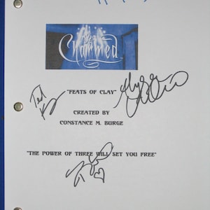 May include: A white script font reads "Charmed" on a blue background with a white star and light beams. The script is surrounded by a black border. The text "FEATS OF CLAY" is written in black below the logo. The text "CREATED BY CONSTANCE M. BURGE" is written in black below the text "FEATS OF CLAY". The text "THE POWER OF THREE WILL SET YOU FREE" is written in black below the text "CREATED BY CONSTANCE M. BURGE". There are three signatures in black ink on the page.