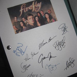 May include: A white framed photograph of the cast of the TV show "Firefly" with their autographs. The cast members include Nathan Fillion, Gina Torres, Alan Tudyk, Morena Baccarin, Adam Baldwin, Jewel Staite, Sean Maher, and Summer Glau.