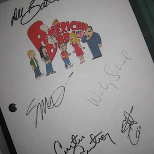May include: White paper with signatures from the cast of the animated television show American Dad. The signatures include Seth MacFarlane, Wendy Schaal, Rachael MacFarlane, and  the show's creator, Seth MacFarlane.