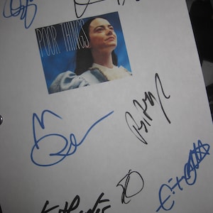 May include: A white sheet of paper with several signatures in black and blue ink. The signatures include "Poor Things", "K. Hunter", "E.T. Oates", and "B.B.". There is a photo of a woman with the title "Poor Things" above the signatures.