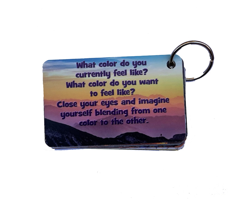May include: A colorful keychain with a motivational message: "What color do you currently feel like? What color do you want to feel like? Close your eyes and imagine yourself blending from one color to the other."