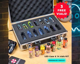 May include: A silver LED case with a black foam interior holds 14 vials of various colors. The text "3 FREE VIALS!" is on a red starburst. The text "LED Case & 14 vials KIT" and "PERSONALIZE YOUR KIT!" are also visible.