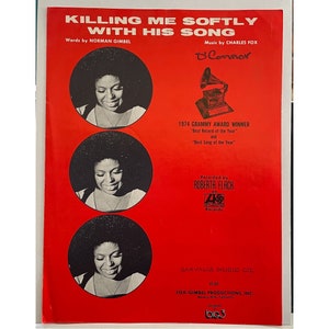 May include: A red sheet music cover with a black and white photo of Roberta Flack. The title of the song is "Killing Me Softly With His Song" and the sheet music is a 1974 Grammy Award winner for "Best Record of the Year" and "Best Song of the Year".