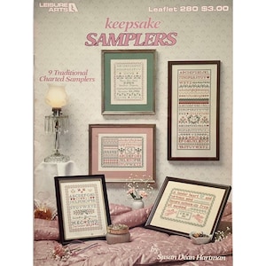May include: A booklet titled "Keepsake Samplers" featuring nine traditional charted samplers. The booklet cover features a pink and green floral pattern and includes the text "Leaflet 280 $3.00".