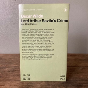 May include: A Penguin Modern Classics paperback book cover featuring a portrait of Oscar Wilde, the author of "Lord Arthur Savile's Crime and Other Stories". The cover is designed by Germano Facetti and features a detail depicting Oscar Wilde from 'A Private View, 1881' by W. P. Frith.
