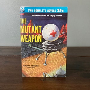 May include: A vintage paperback book cover with a red, white, and blue illustration of a spaceship landing on a planet. The title is "The Mutant Weapon" by Murray Leinster. The book is part of the Ace Double Novels series and costs 35 cents.