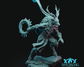 May include: A detailed, teal-colored figurine of a mythical creature with antlers, fur, and armor, holding a crescent-shaped weapon. The figure is posed dynamically on a stone base. The text "WITCHSONG" is visible in the lower right corner.
