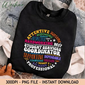 May include: A black crewneck sweatshirt featuring a circular graphic design with the text "STUDENT SERVICES COORDINATOR" in large white letters, surrounded by colorful words including "ATTENTIVE," "RESPONSIBLE," "RESPECTFUL," and "PROFESSIONAL."