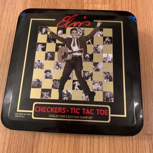 May include: A black tin game box with a gold trim featuring a photo of Elvis Presley in a checkered pattern. The box says "Checkers & Tic Tac Toe Collector's Edition Game Set" and "For ages six years and up (6+)".