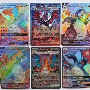 May include: Six collectible trading cards featuring Charizard in various forms, including GX and VMAX versions. The cards display vibrant holographic artwork, detailed character illustrations, attack statistics, and text in English.