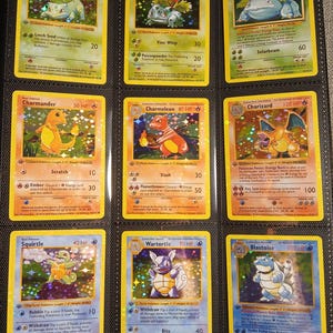 May include: Nine Pokémon trading cards in a binder. The cards feature characters like Bulbasaur, Ivysaur, Venusaur, Charmander, Charmeleon, Charizard, Squirtle, Wartortle, and Blastoise. Each card has a unique design and HP, with text describing attacks.