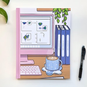 May include: An illustrated notebook with a pink and white cover featuring a computer screen displaying a graph and a cup of coffee with a blue and white design. The notebook has the text "Lab notebook #1", "Lab notebook #2", and "Lab notebook #3" on the spine.