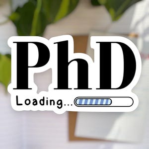 May include: A white sticker featuring the letters "PhD" in a bold black font. Beneath, the word "Loading..." is written in black. A blue and white loading bar graphic is also included, suggesting progress.