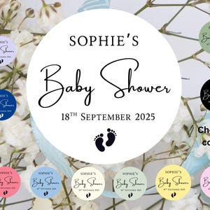 May include: Baby shower stickers with the text "Sophie's Baby Shower 18th September 2025" and baby footprints. Available in various colours, including blue, pink, and green. Ideal for baby shower favours.