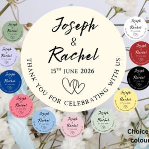 May include: A collection of circular stickers in various colours, featuring the names Joseph and Rachel, the date 15th June 2026, and the text Thank You For Celebrating With Us, accompanied by a line-art illustration of two interlocking hearts.