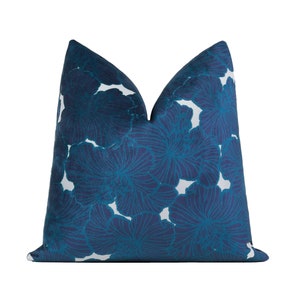 May include: A blue and white floral patterned throw pillow. The pillow is made of a soft, luxurious fabric and features a bold floral design.