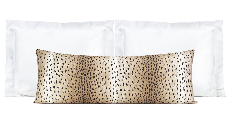 May include: Two white standard pillowcases and a brown and black patterned lumbar pillow. The lumbar pillow has a cheetah print pattern.