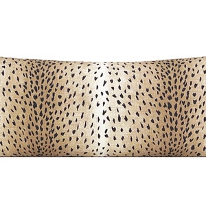 May include: A long, rectangular throw pillow with a brown and black cheetah print pattern.