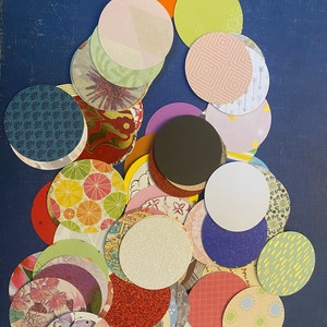 May include: A collection of colorful paper circles with various patterns and textures. The circles are arranged in a random pattern on a blue background.