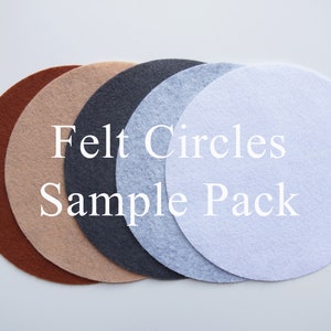 May include: A sample pack of felt circles in four colors: brown, beige, gray, and white. The circles are arranged in a stack, with the largest circle on the bottom and the smallest circle on top. The text "Felt Circles Sample Pack" is printed in white on the circles.
