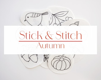 May include: White fabric patches with black line drawings of autumn-themed images, including a bird, berries, acorns, and a pumpkin. The text "Stick & Stitch Autumn" is displayed in a white rectangle.