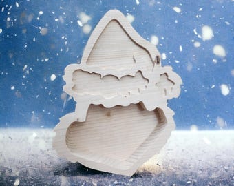May include: A wooden Christmas tree-shaped tray with a heart-shaped base. The tray is made of light-colored wood and has a layered design. The background is a blue gradient with white specks, creating a snowy effect.