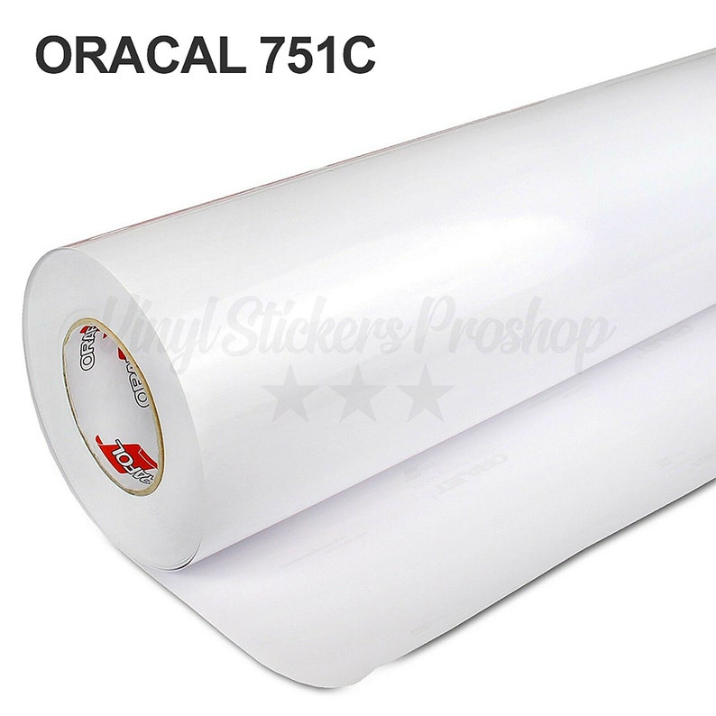 Puede incluir: Un rollo blanco de material adhesivo de vinilo Oracal 751C. El rollo est&aacute; parcialmente desenrollado, revelando el respaldo adhesivo blanco.