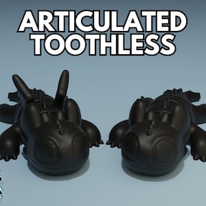 May include: Two black articulated Toothless figures from the How to Train Your Dragon franchise. The figures are posed lying on their bellies with their wings outstretched.