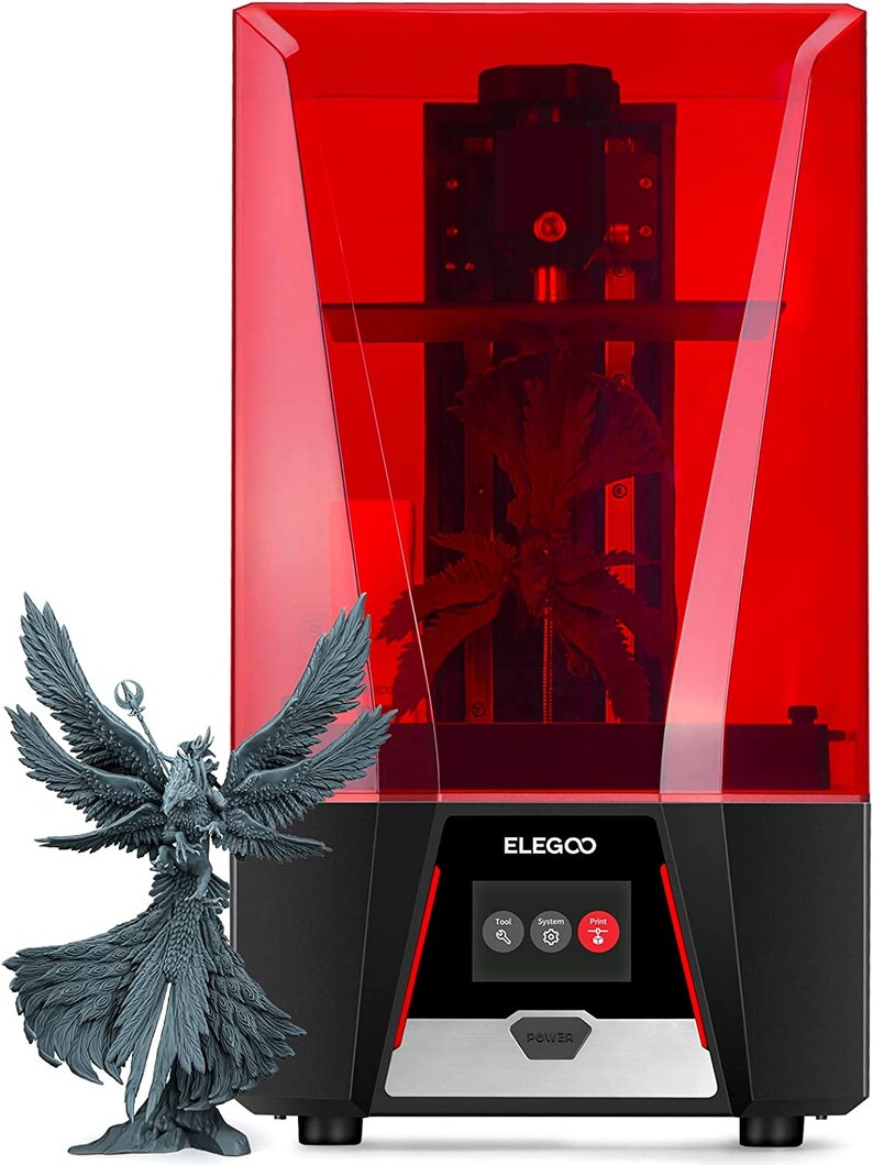 May include: A red 3D printer with a clear plastic enclosure. The printer has a black base with a silver trim and a control panel with buttons for "Tool", "System", and "Print". The printer is printing a gray figurine of a winged creature. The text "ELEGOO" is printed on the front of the printer.