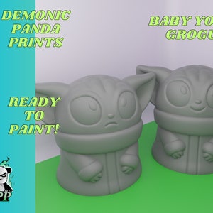 May include: Two unpainted gray 3D printed figurines of Baby Yoda, also known as Grogu, from the Star Wars series The Mandalorian. The figurines are ready to be painted. The text "DEMONIC PANDA PRINTS" and "BABY YODA GROGU" are visible in the image. The text "READY TO PAINT!" is also visible in the image.