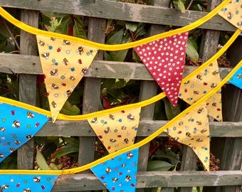 Bee themed fabric bunting, primarily bright yellow flags, double sided with floral design, home and garden decoration / garlands.