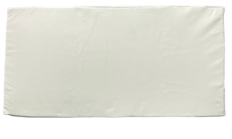 May include: A plain white rectangular fabric tablecloth.