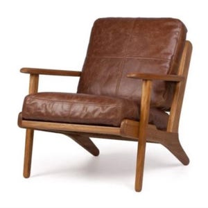 May include: A brown leather armchair with a wooden frame and angled legs. The chair has a tufted back and seat.