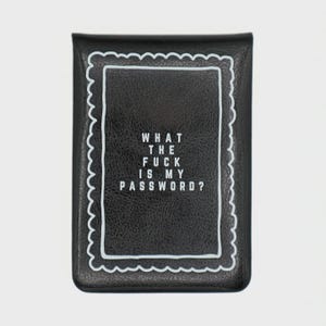 May include: Black wallet with a white scalloped border and the text "WHAT THE FUCK IS MY PASSWORD?" in a white, sans-serif font. The wallet has a rectangular frame around the text.