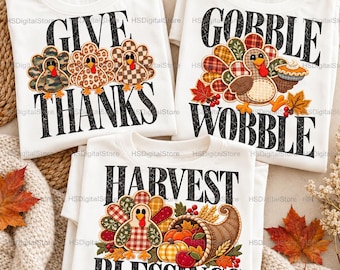 May include: Three white t-shirts featuring Thanksgiving-themed graphics. One shirt says GIVE THANKS with three turkeys, one says GOBBLE WOBBLE with a turkey holding a pie, and one says HARVEST BLESSINGS with a turkey and a cornucopia.