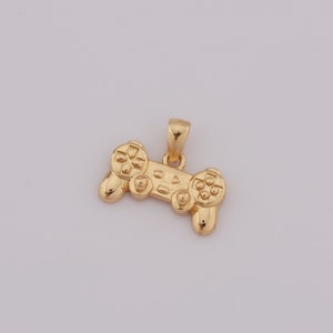 May include: A gold-colored pendant shaped like a video game controller.