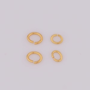 May include: Four gold jump rings of different sizes. The rings are smooth and shiny.