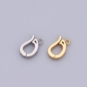Peut inclure: Deux fermoirs métalliques, l'un argenté et l'autre doré, pour la fabrication de bijoux. Les fermoirs sont en forme de larme avec une petite boucle en haut.