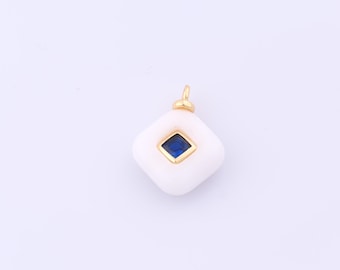 May include: A white, square pendant with a gold bail. The pendant features a square, deep blue gemstone set in a gold frame. The pendant is a simple, elegant piece of jewellery.